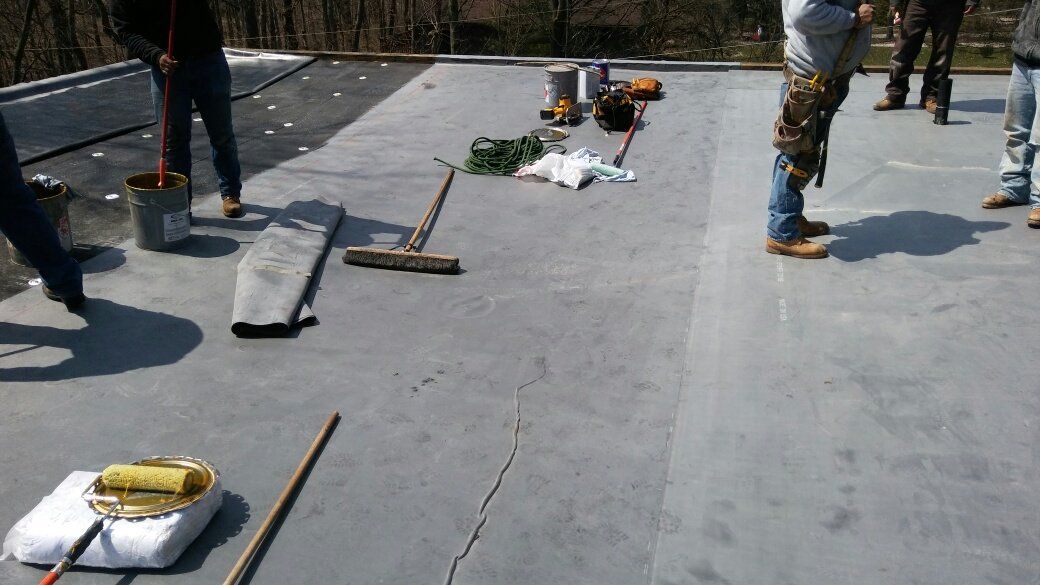 A group of people are working on a roof.