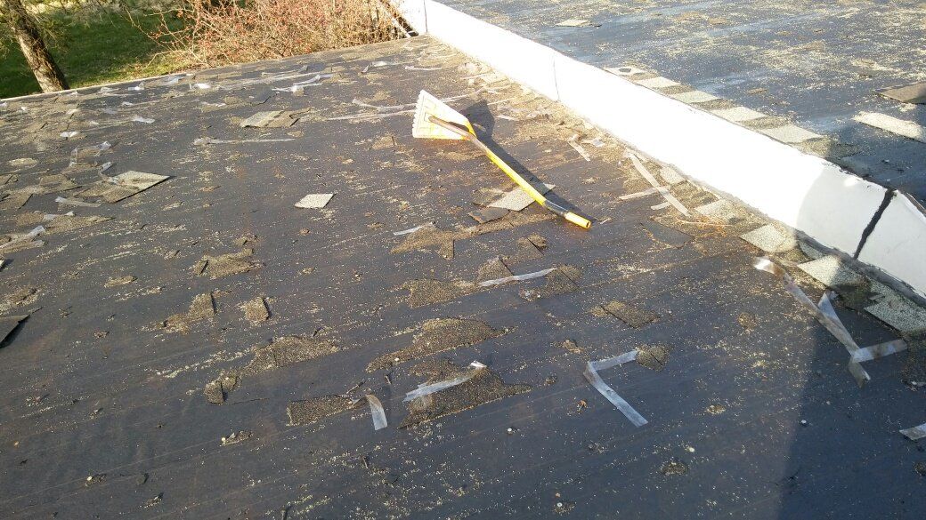 A close up of a roof with a yellow stick on it.
