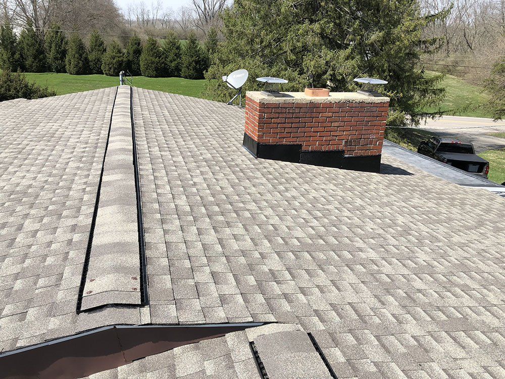 A roof with a brick chimney on top of it.