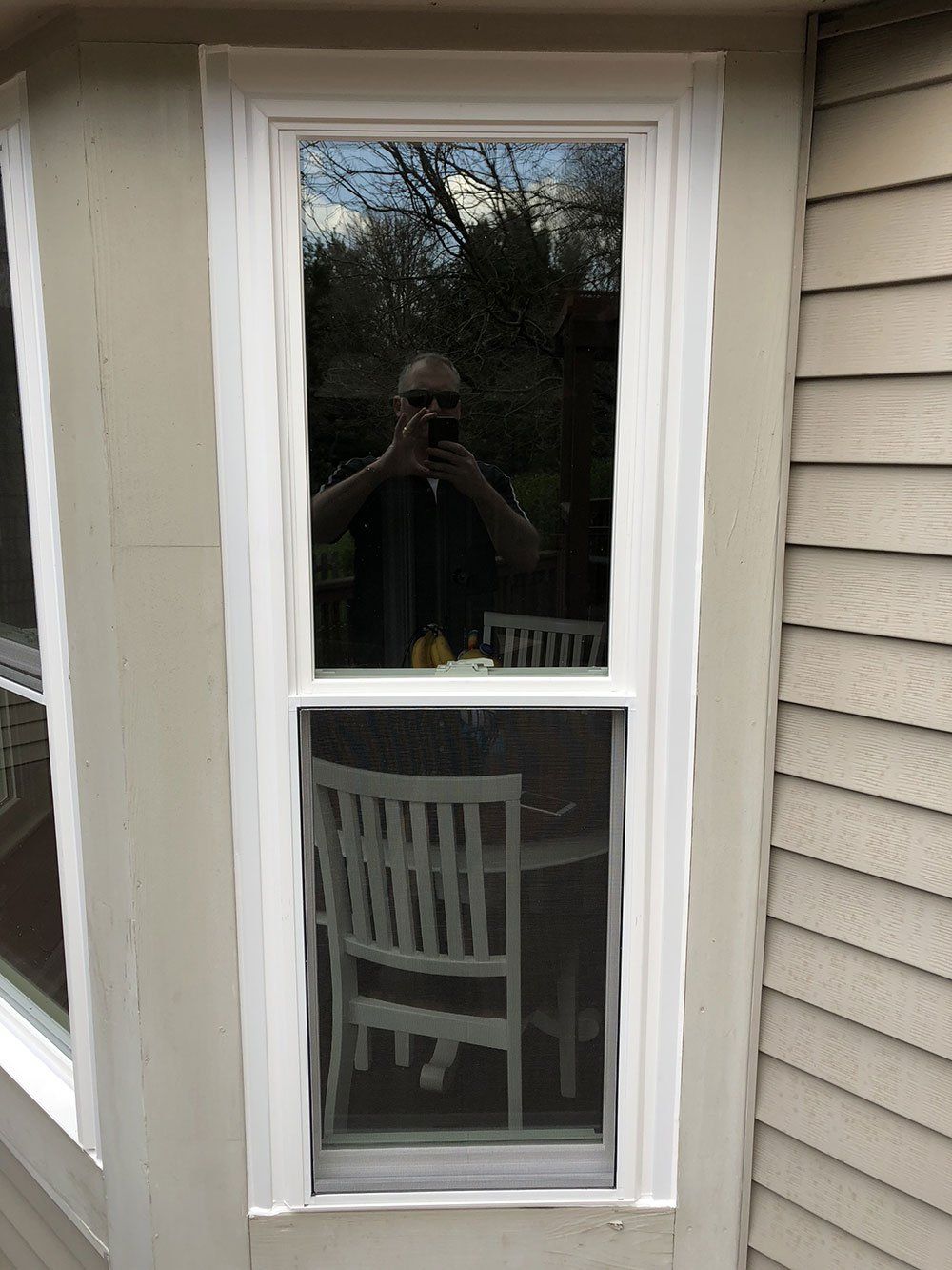 A man is taking a picture of himself in a window.