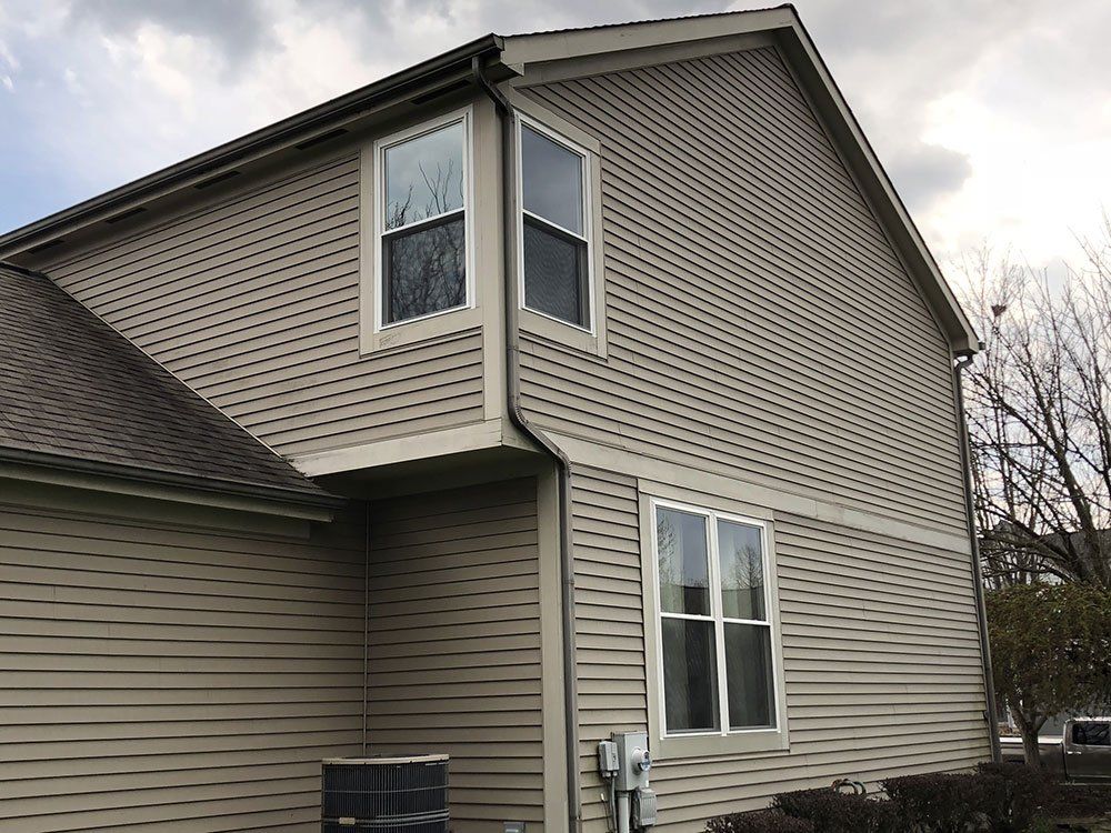 A house with a lot of windows and a roof.