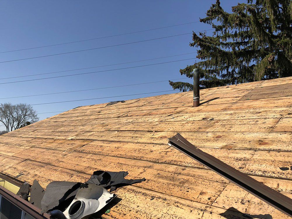 A roof with a few pieces of wood on it.