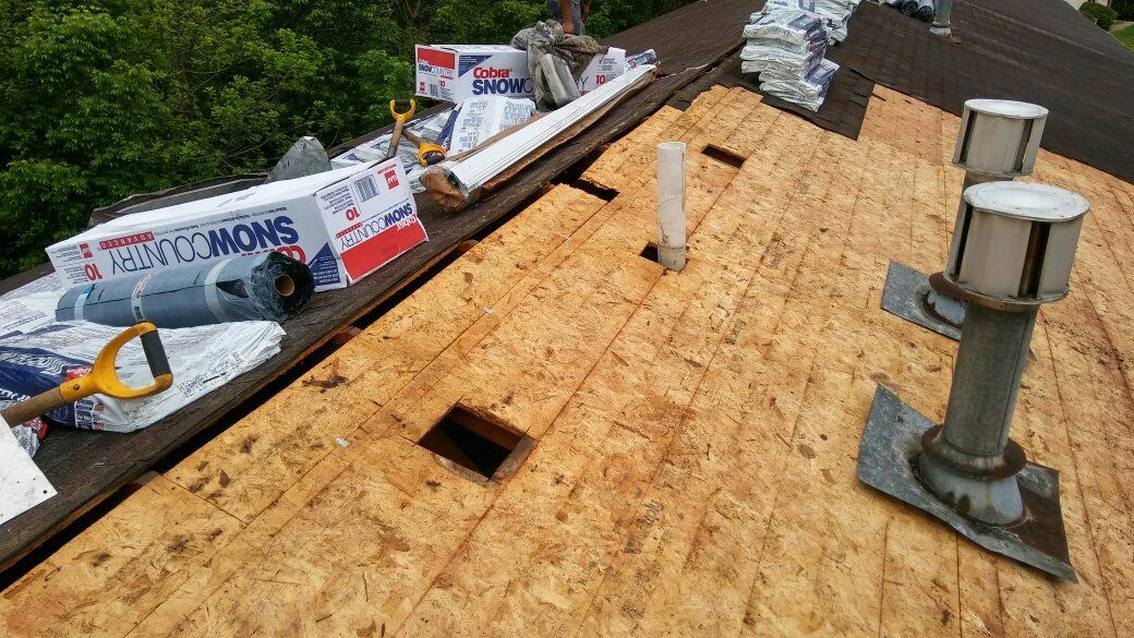 The roof of a house is being repaired and there is a hole in the roof.