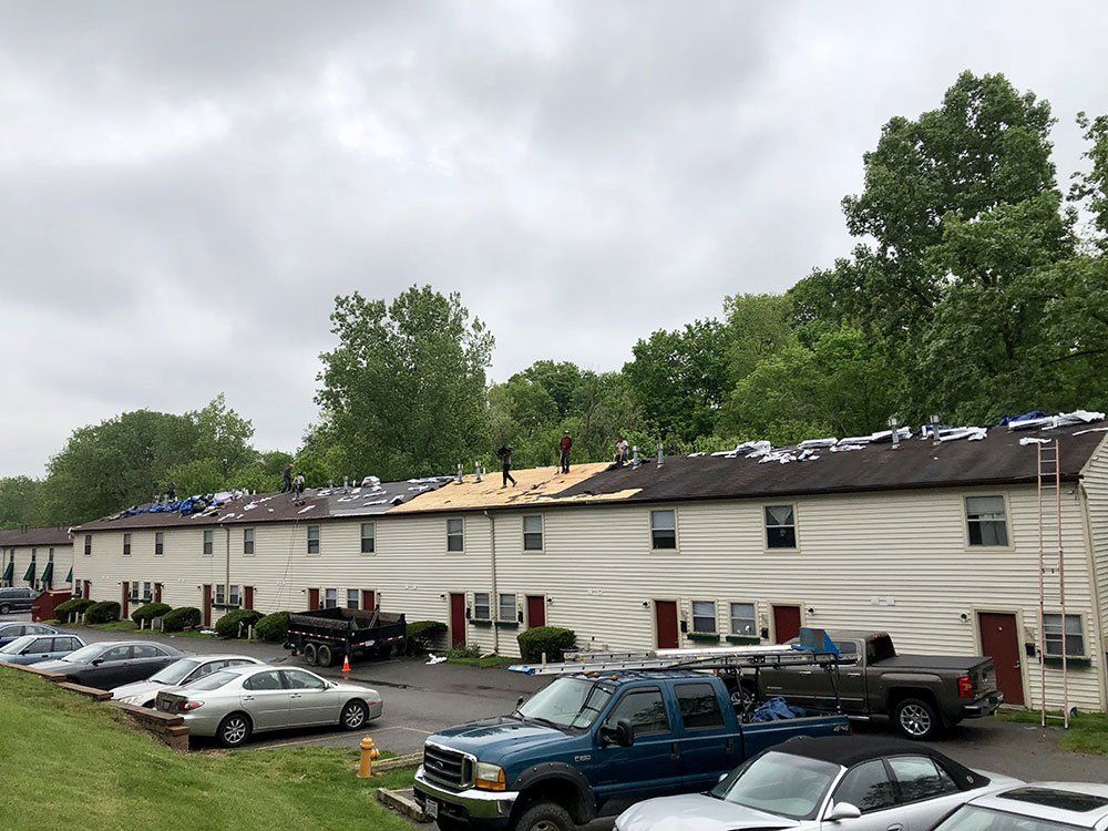 A group of cars are parked in front of a building that is being remodeled.