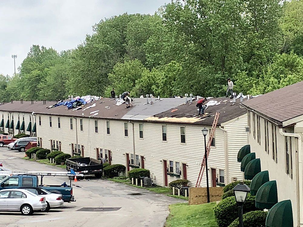 A group of people are working on the roof of a building.