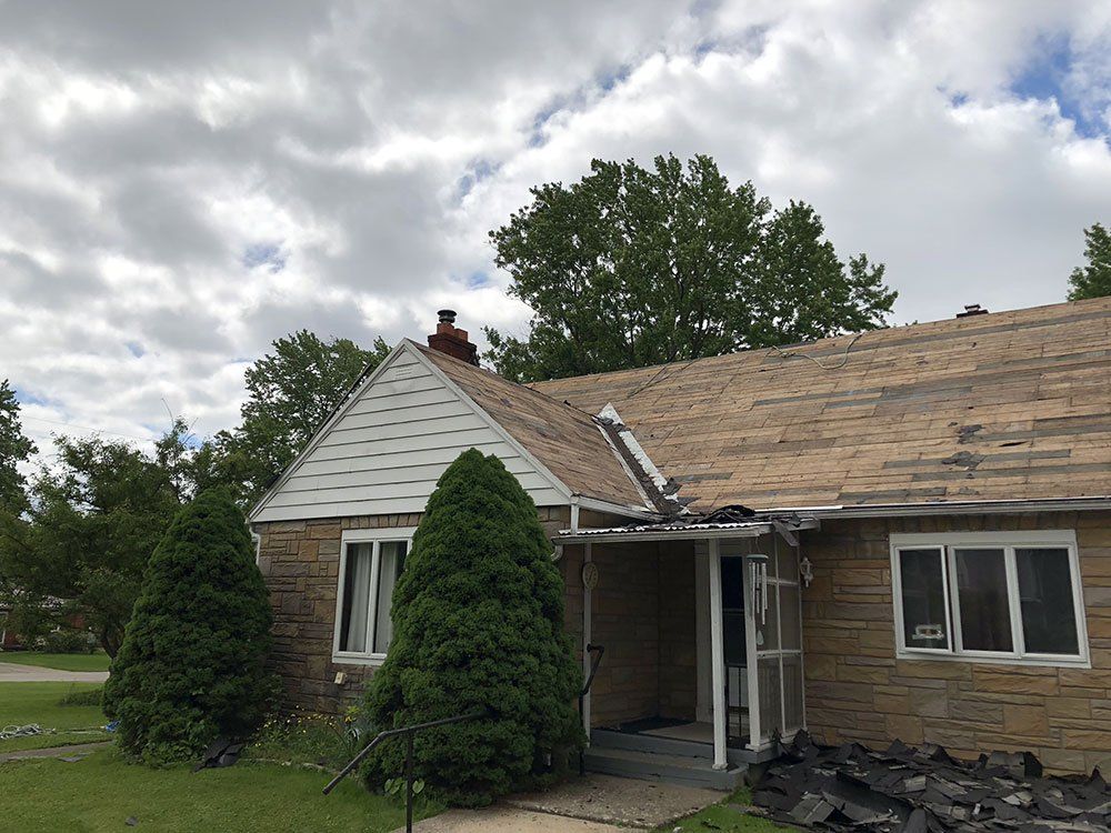 A house with a roof that has been damaged by a fire.