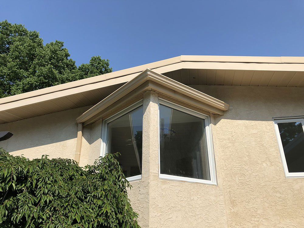 A house with a large window on the side of it.