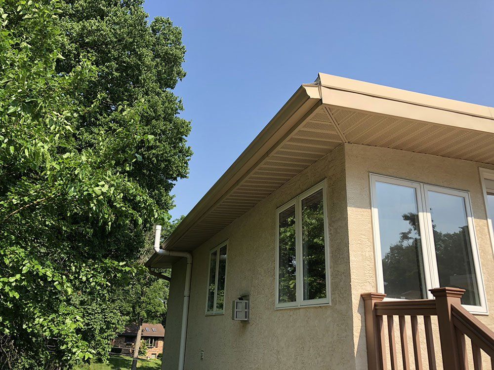 A house with a lot of windows and a tree in front of it