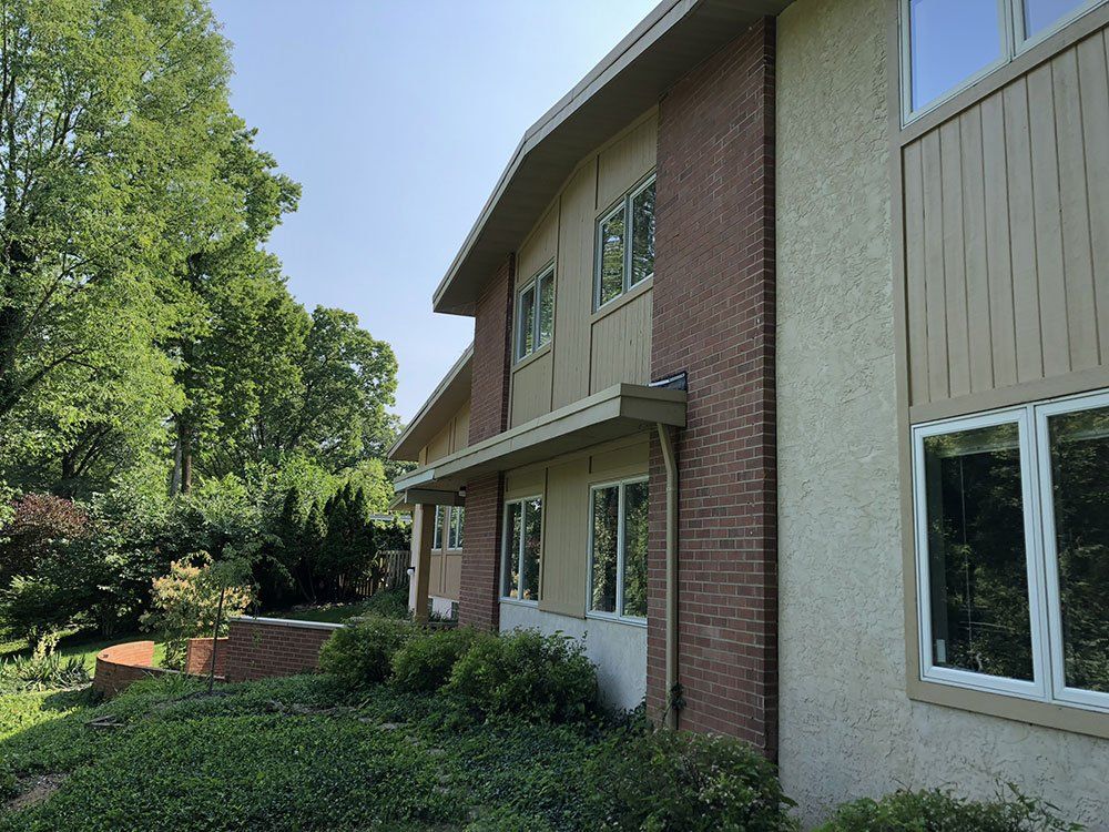 A large building with a lot of windows and trees in the background