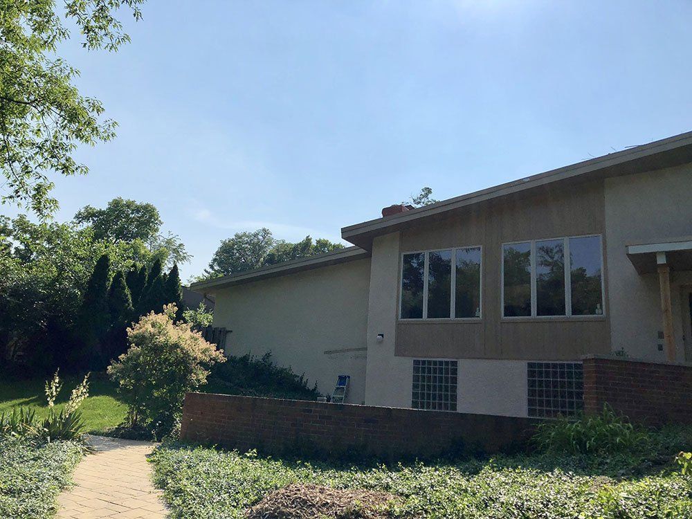 A large house with a lot of windows and a path leading to it.