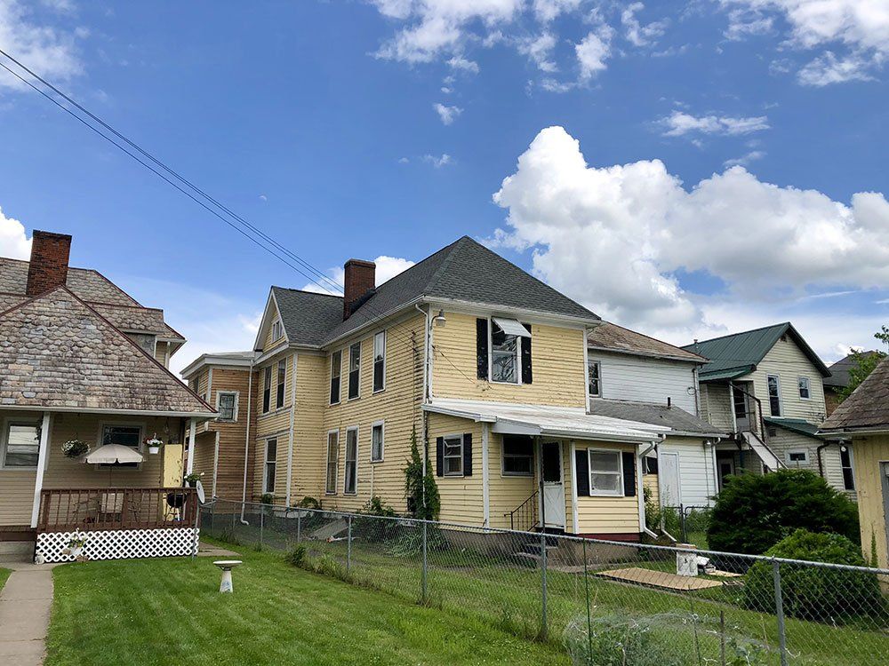 A row of houses sitting next to each other on a sunny day.