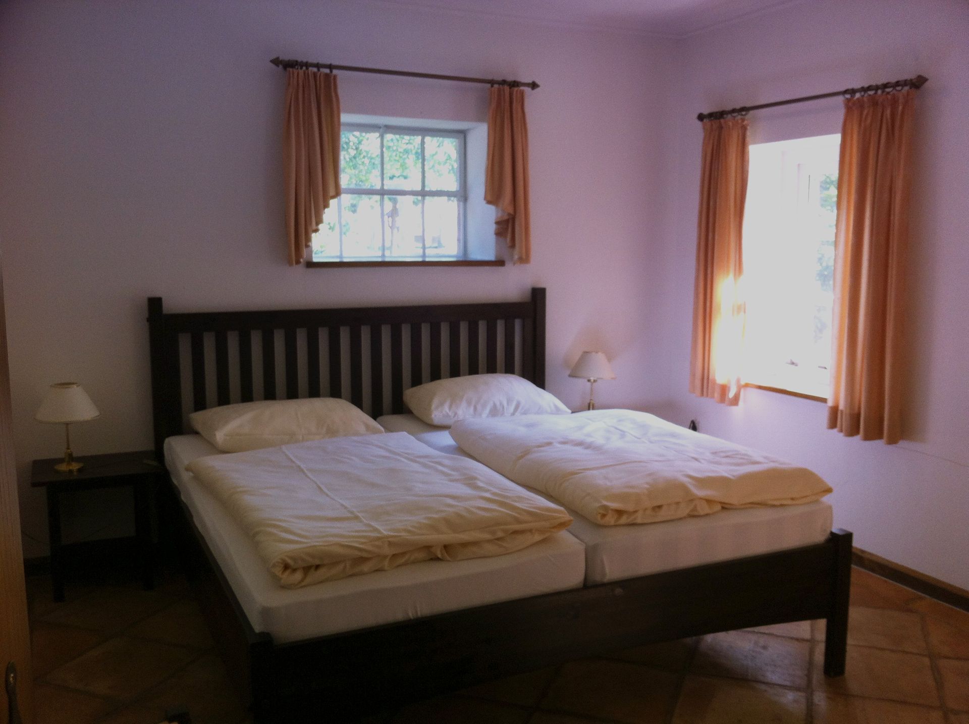 Een slaapkamer met twee bedden en een raam