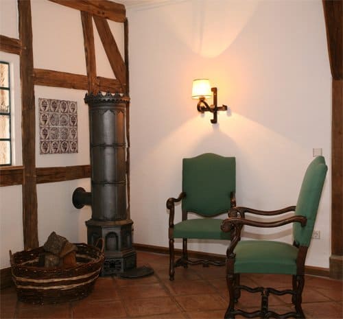 Ein Raum mit einem Stuhl und einem Korb mit Holzscheiten
