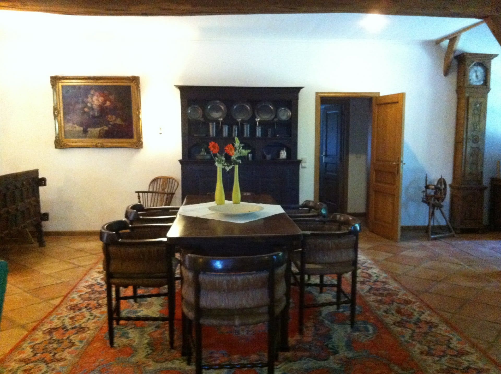 Ein Esszimmer mit Tisch und Stühlen und einem Gemälde an der Wand