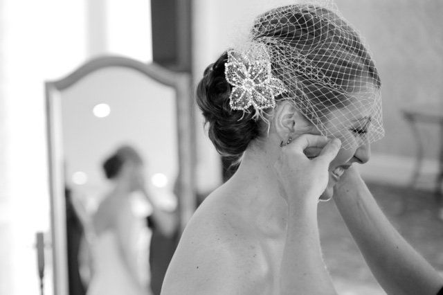 A black and white photo of a bride getting ready for her wedding.