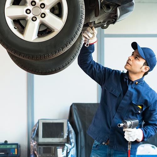 Auto Repair Service — Mechanic at Work in His Garage in Santa Cruz, CA Auto Repair Service — Mechanic at Work in His Garage in Santa Cruz, CA