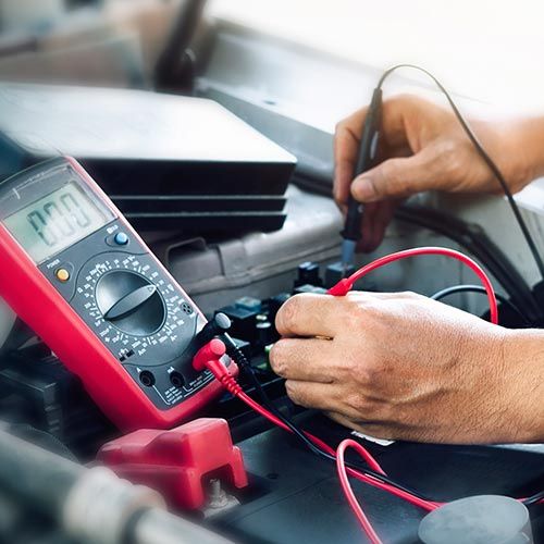 Auto Electrical Service — Mechanic Checking the Battery in Santa Cruz, CA Auto Electrical Service — Mechanic Checking the Battery in Santa Cruz, CA