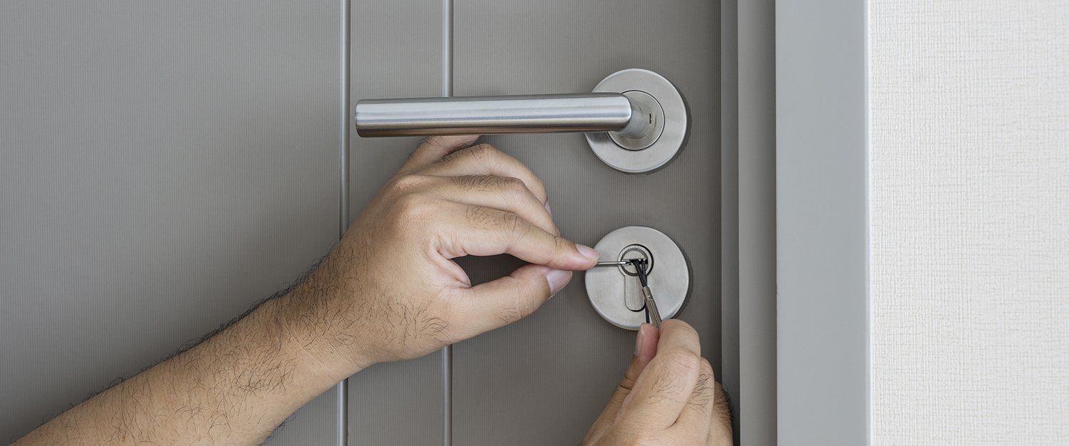 Man Trying to fix Door Lock — Safe N Sound Locksmiths in Varsity Lakes, QLD