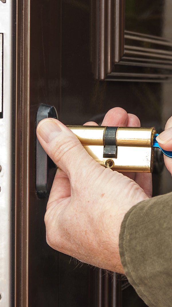 Locksmith Repairing the Lock on a Door — Safe N Sound Locksmiths in Varsity Lakes, QLD