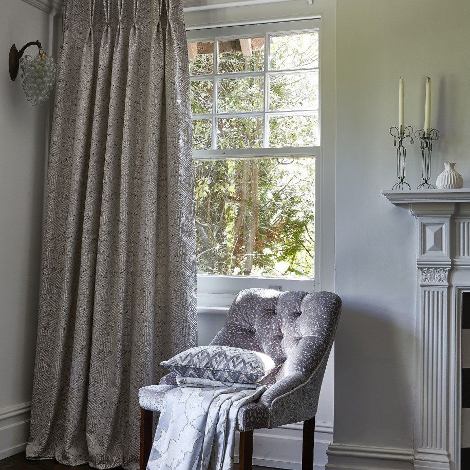 Regal grey curtains with contemporary pattern and berry-style wall light