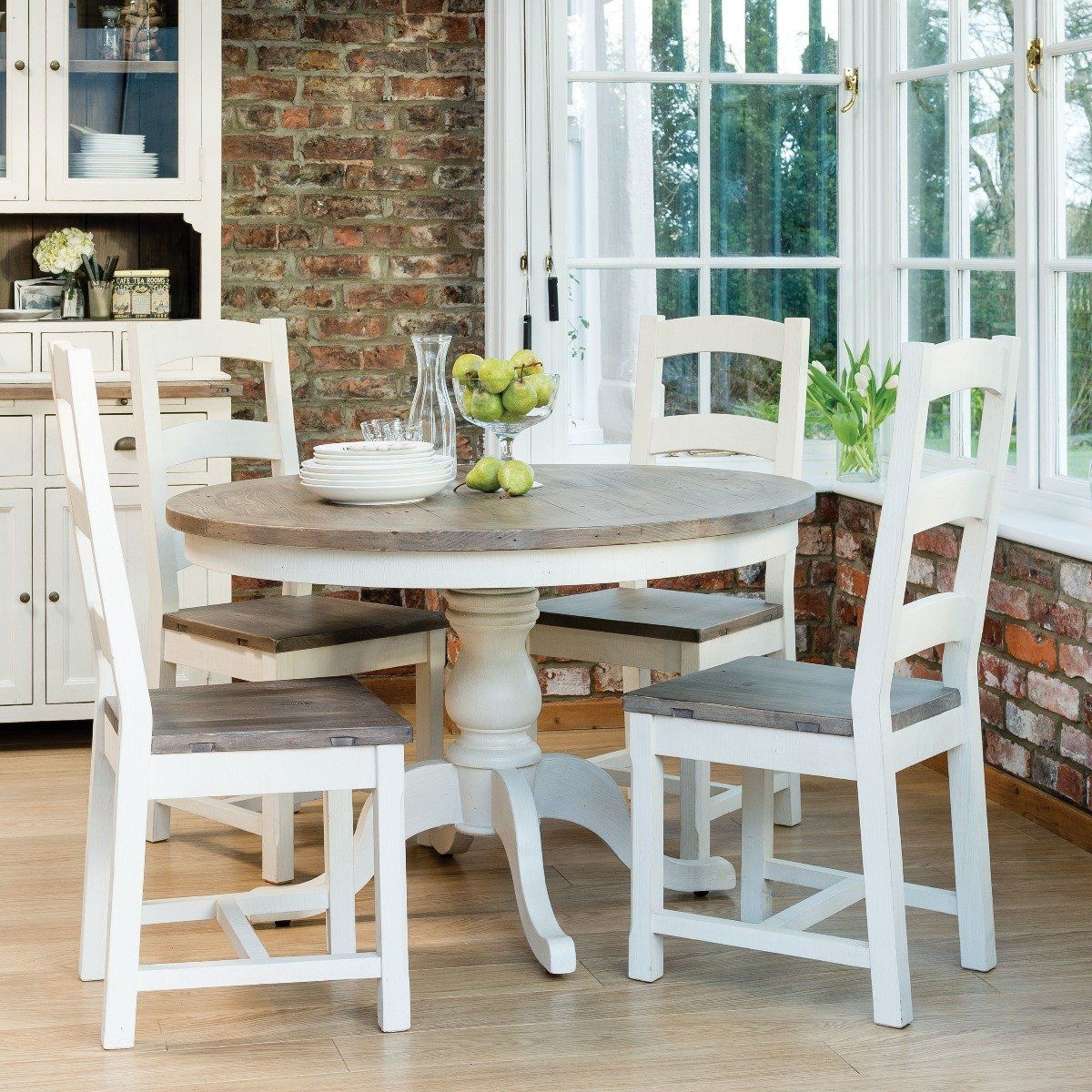 Cotswold dining room furniture in a sleek white room with wildlife accent
