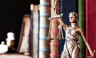 Statue of justice and book of law - attorneys in Salem, MA