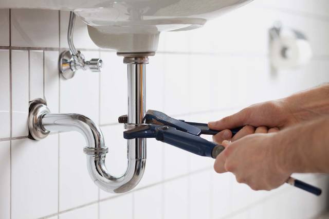 Plumber Using Wrench on Pipe — Linden, VA — Brinson & Son Plumbing Company, LLC