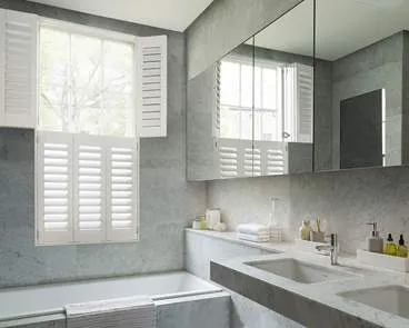 Tier-on-tier white shutters in bathroom