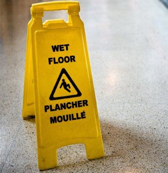 Wet Floor Sign In Hallway — Floor in Fort Walton Beach, FL Wet Floor Sign In Hallway — Floor in Fort Walton Beach, FL