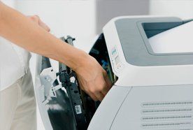 an engineer fixing a printer
