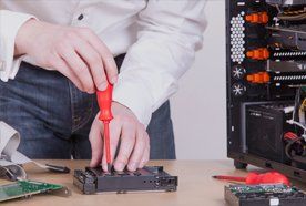 a man fixing a computer