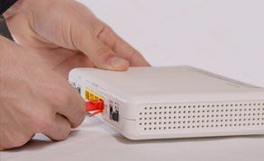 a man plugging a router in