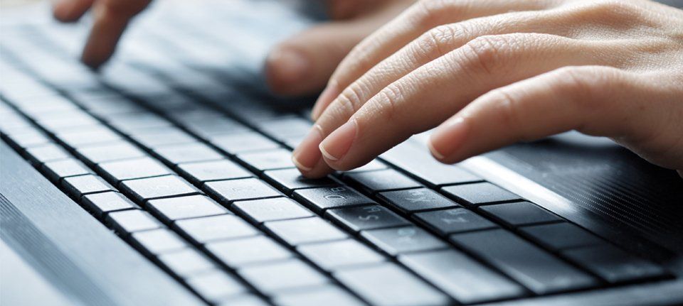 a woman tapping on a keyboard
