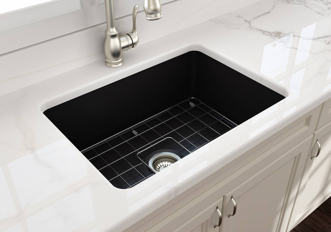 An underbench mounted black butlers sink An underbench mounted black butlers sink