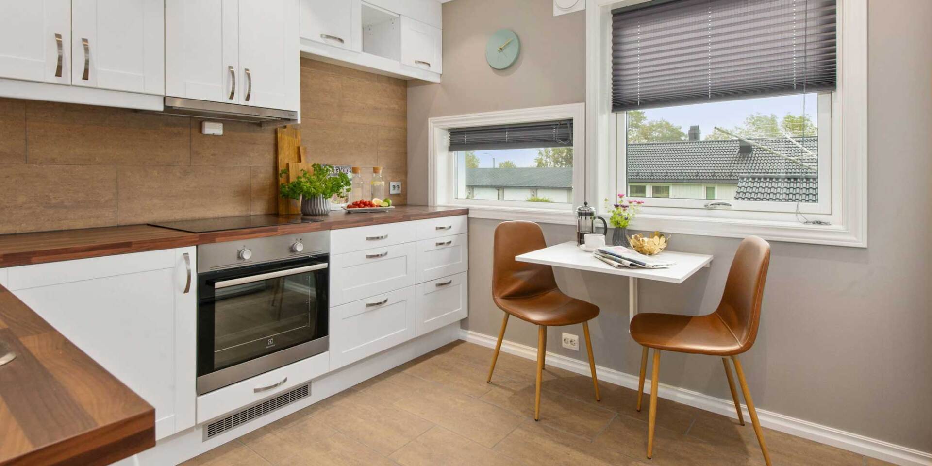 Tie in your kitchen elements with your backsplash Timber tile backsplash in a smaller white kitchen.