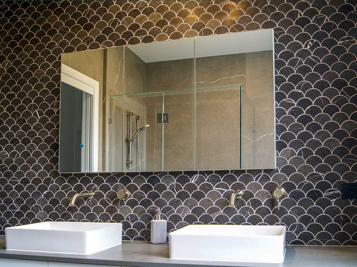 Custom marble tile with dual sinks in a master ensuite