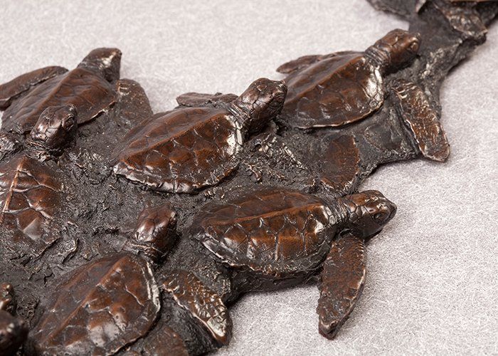 green sea turtle hatchlings sculpture in bronze