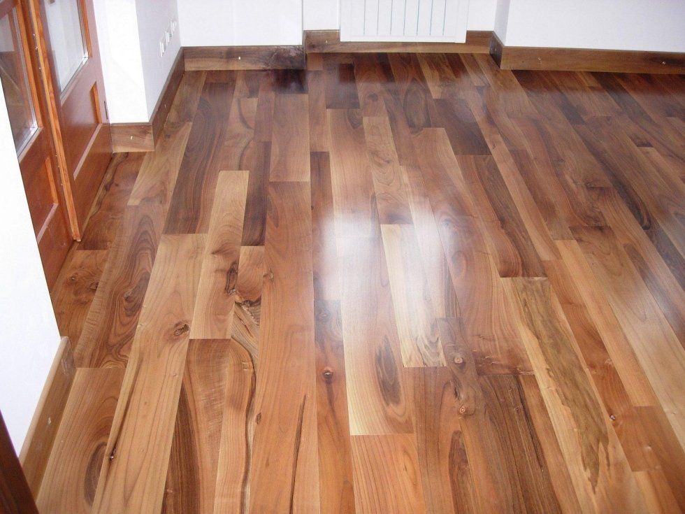 Pavimento in legno con varie tonalità di marrone, lucido e levigato.
