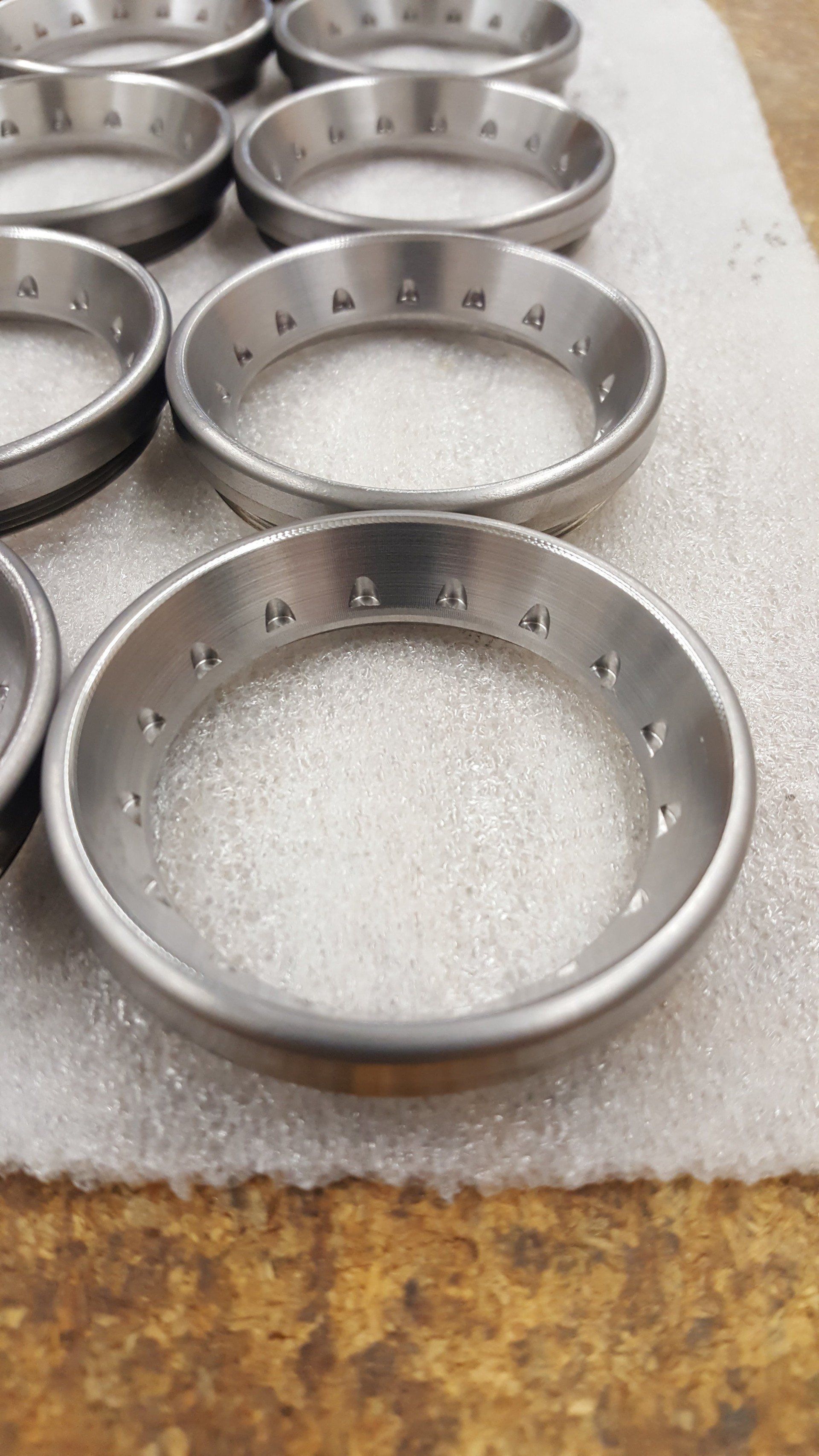 A bunch of metal rings are sitting on top of each other on a table.