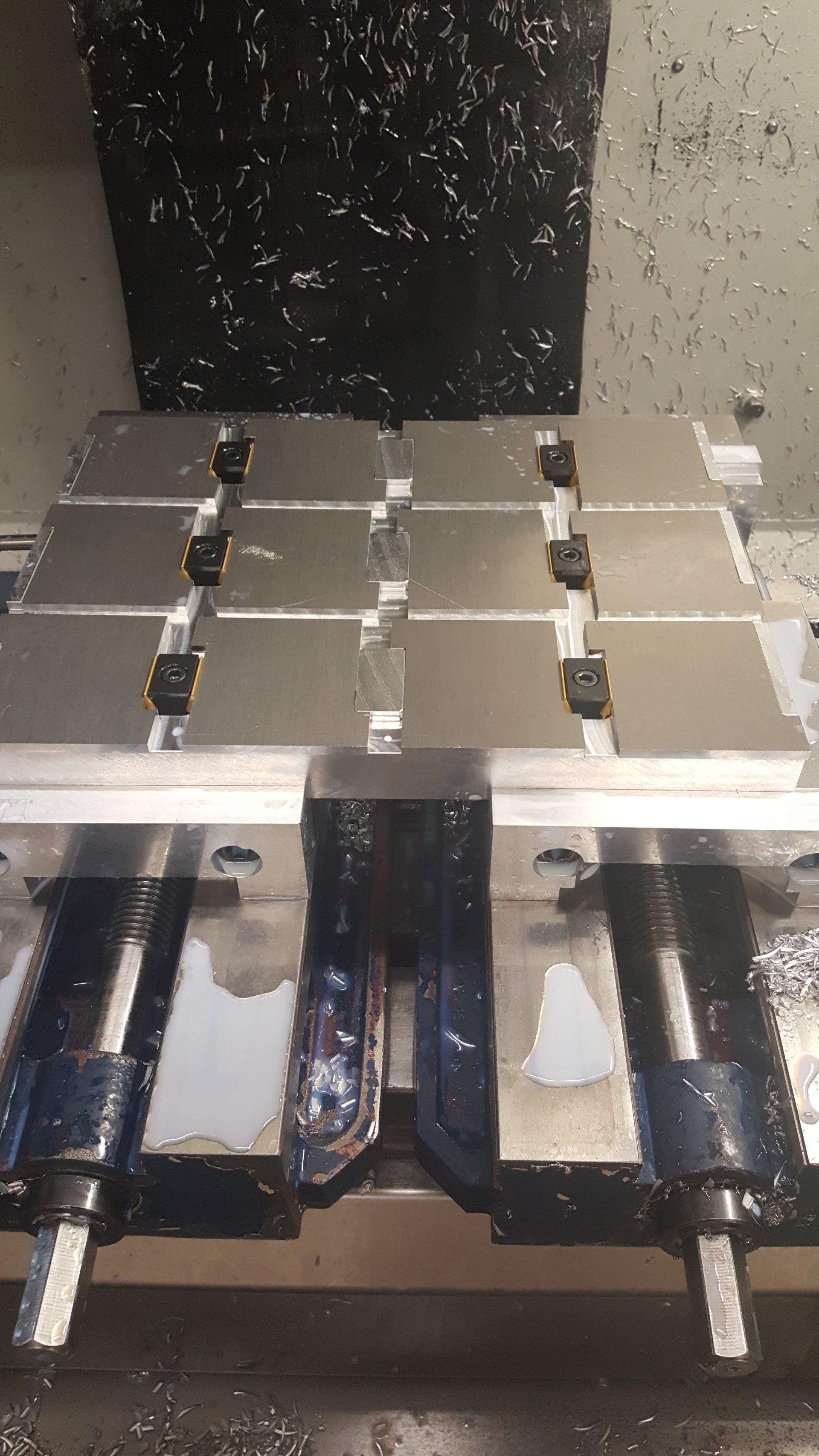 A machine is cutting a piece of metal on a table.