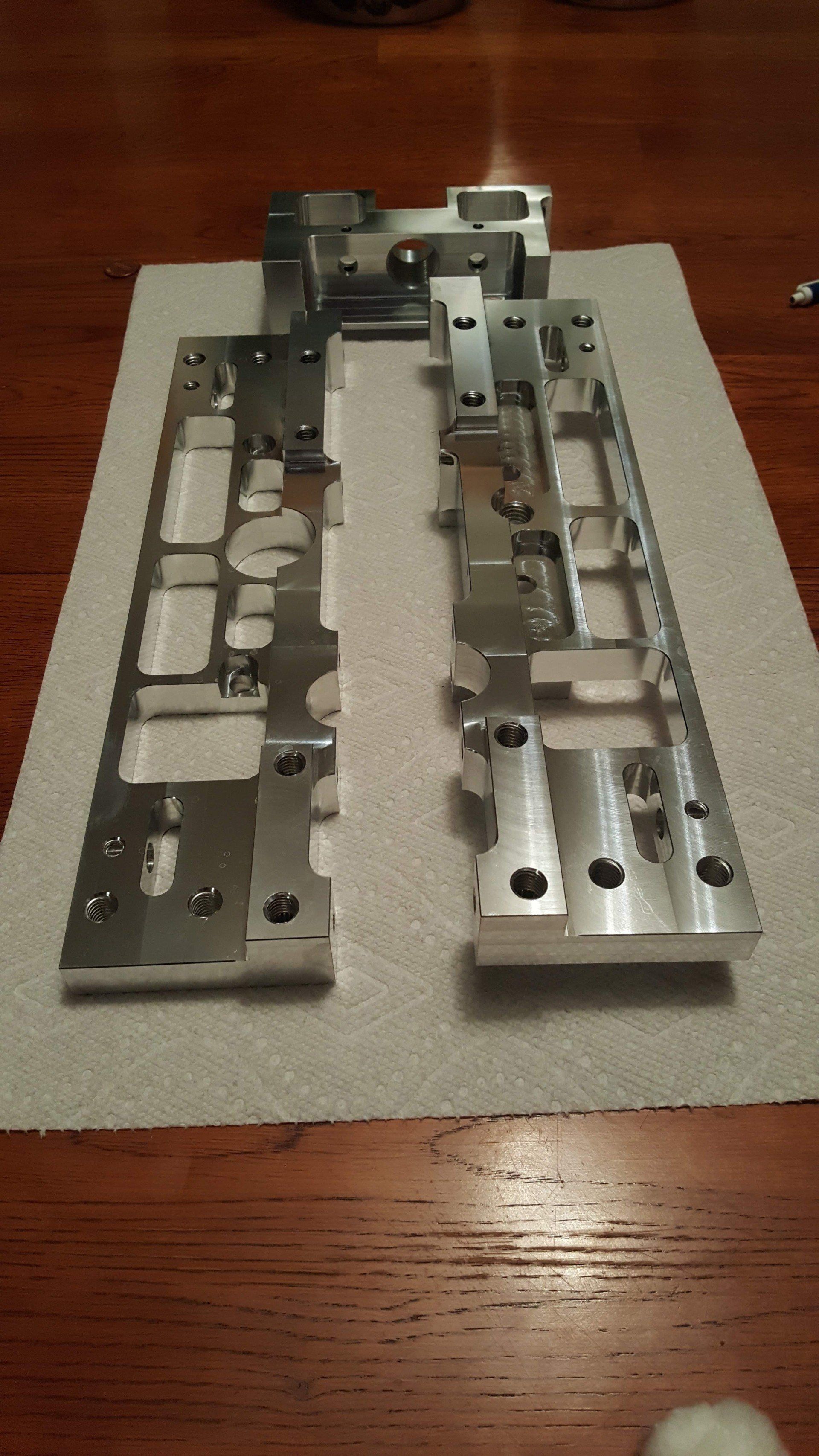 A piece of metal is sitting on a piece of paper on a wooden table.