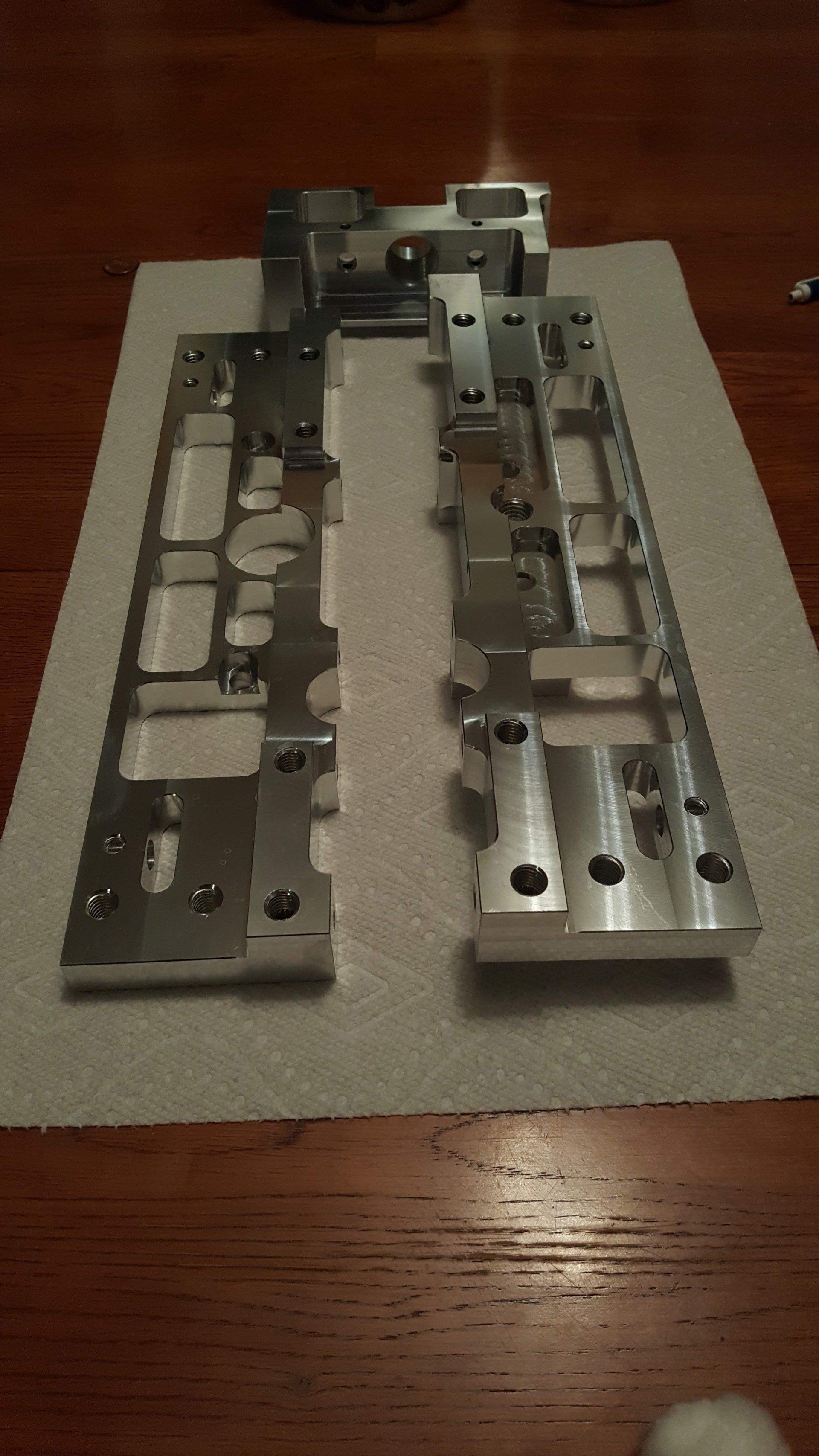 A piece of metal is sitting on a piece of paper on a wooden table.