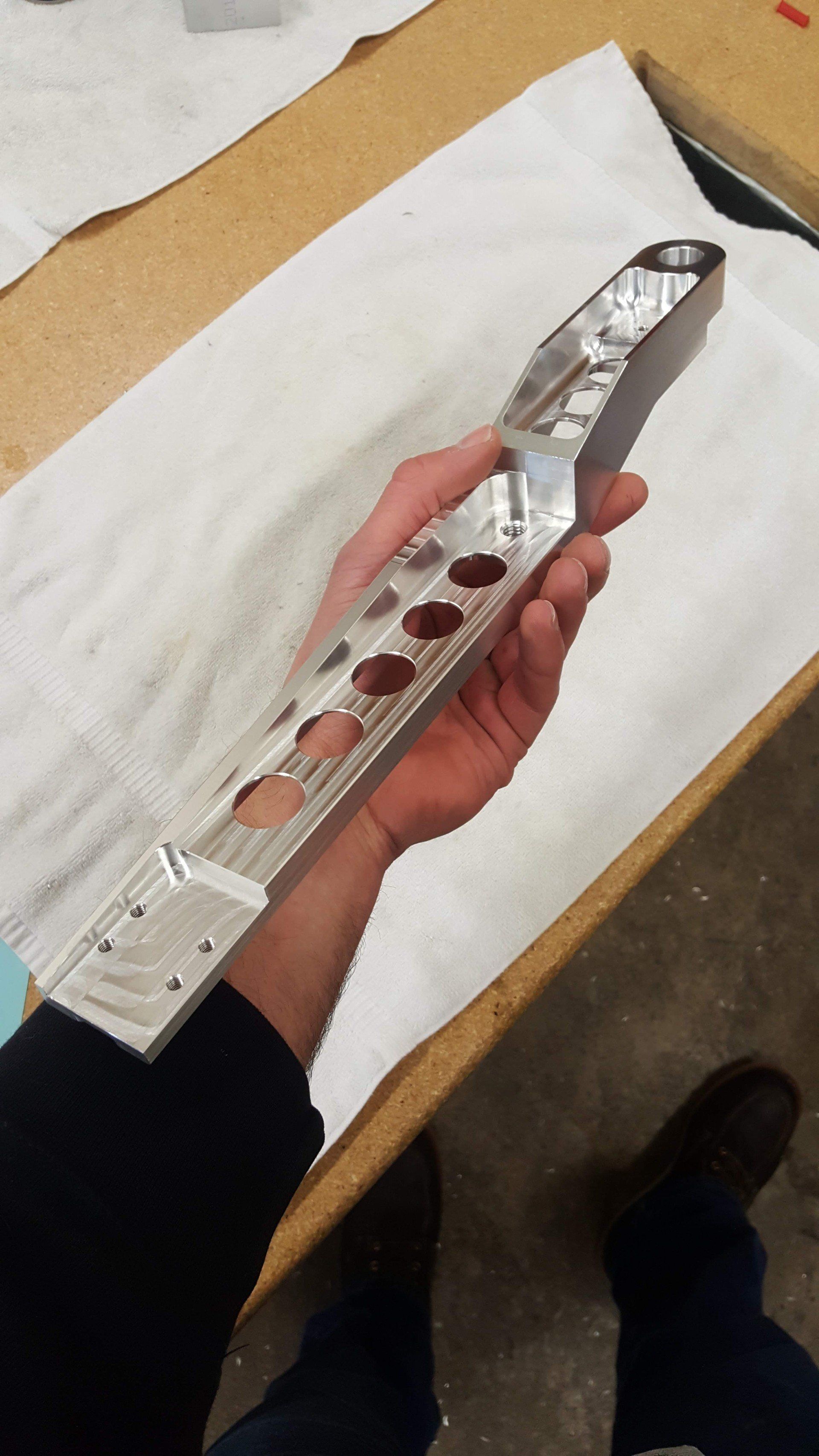A person is holding a piece of metal in their hand.