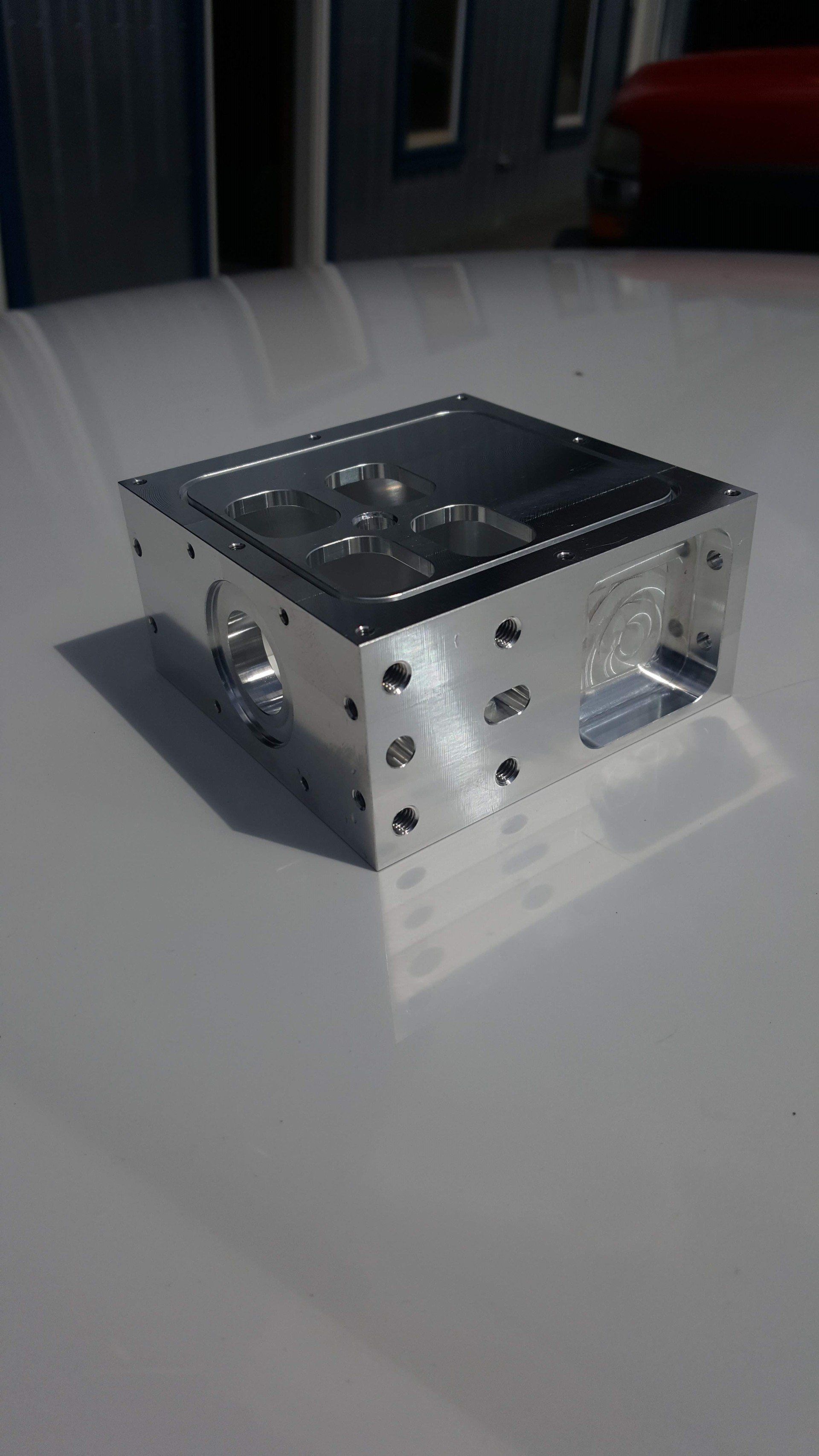 A small metal box is sitting on top of a white table.