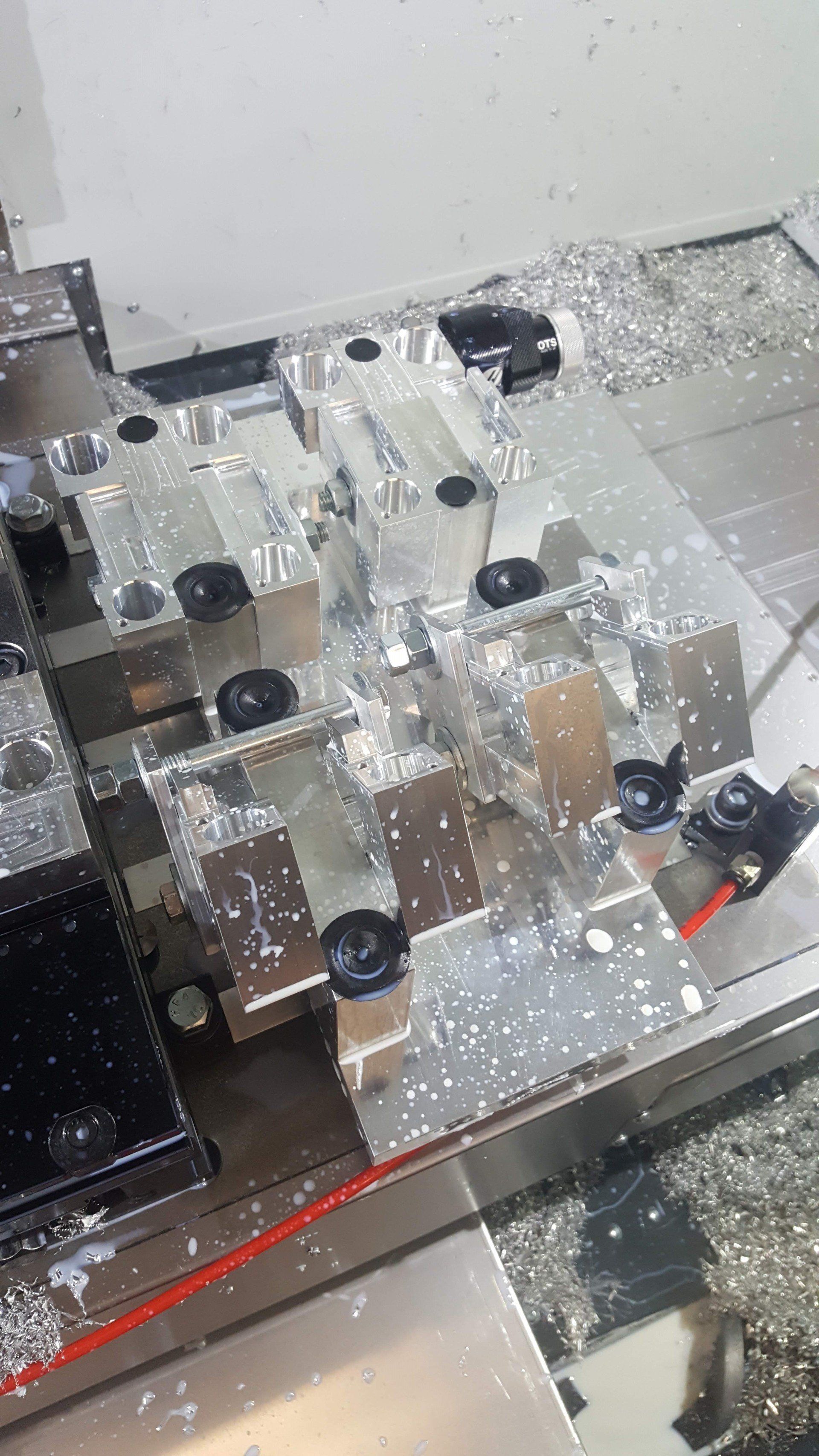 A machine is cutting a piece of metal on a table.
