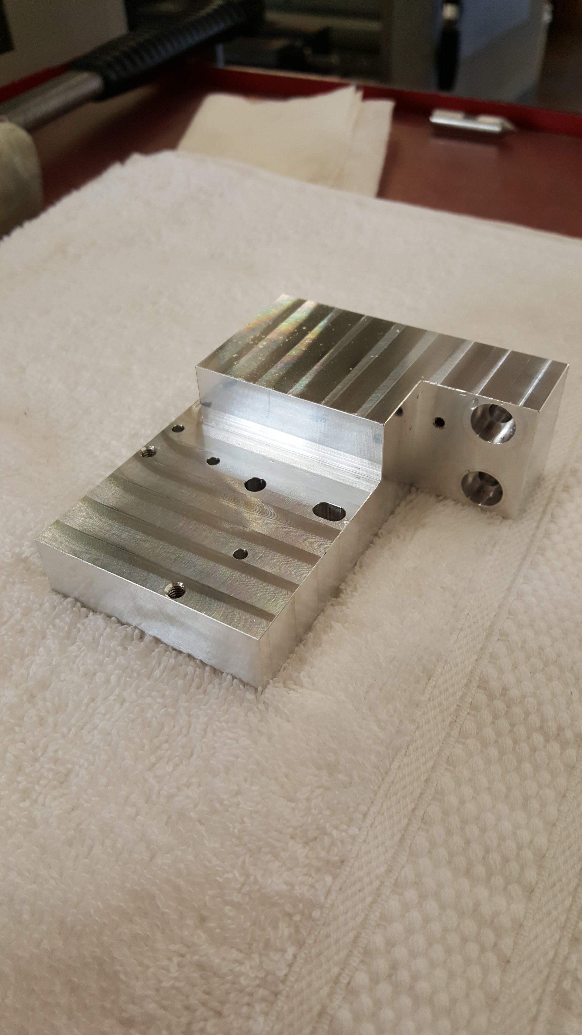 A piece of metal is sitting on top of a towel on a table.
