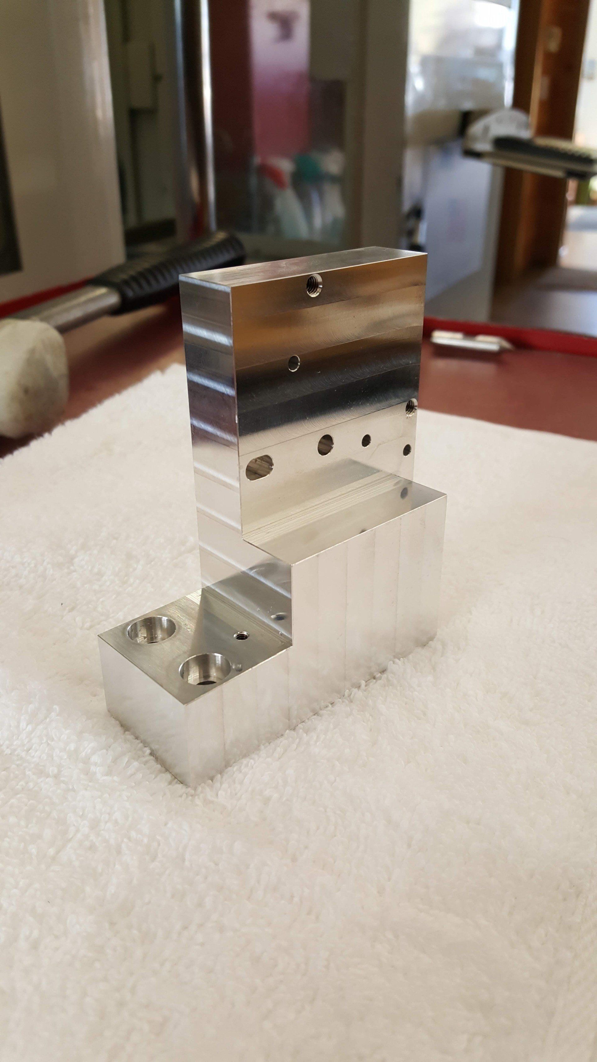 A piece of metal is sitting on top of a white towel on a table.