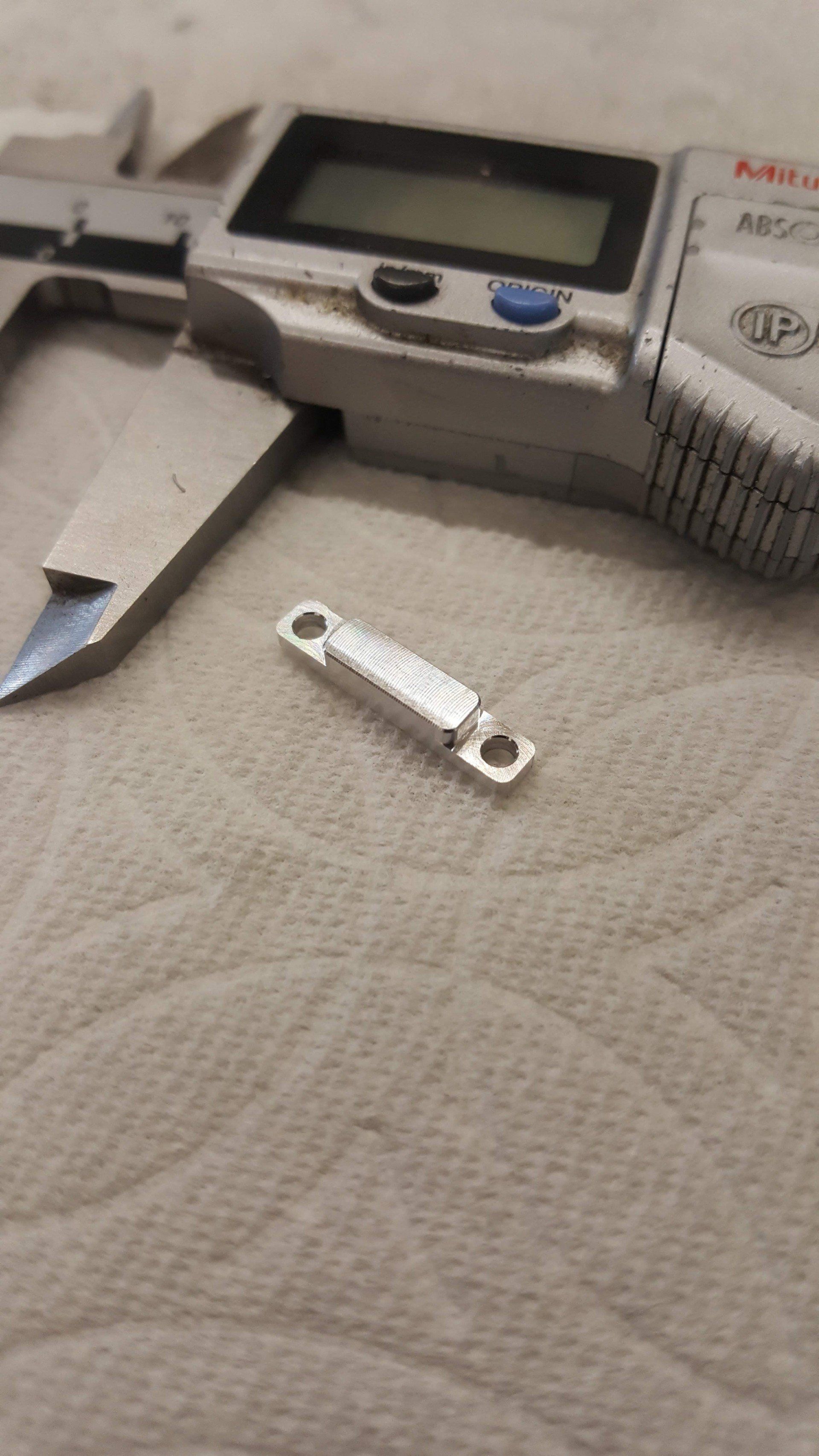 A digital caliper is sitting on top of a piece of paper.
