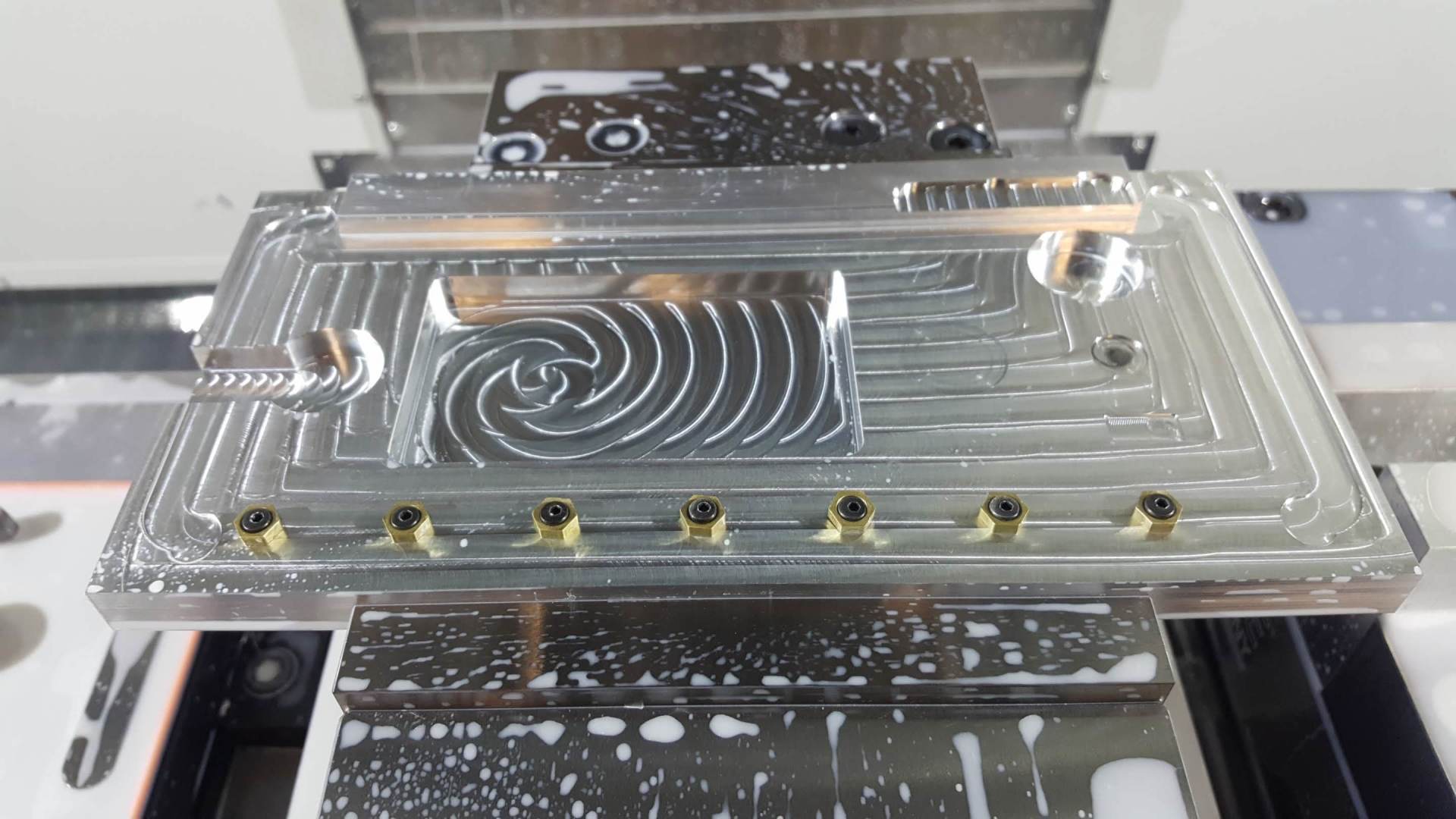A piece of metal is sitting on top of a machine.