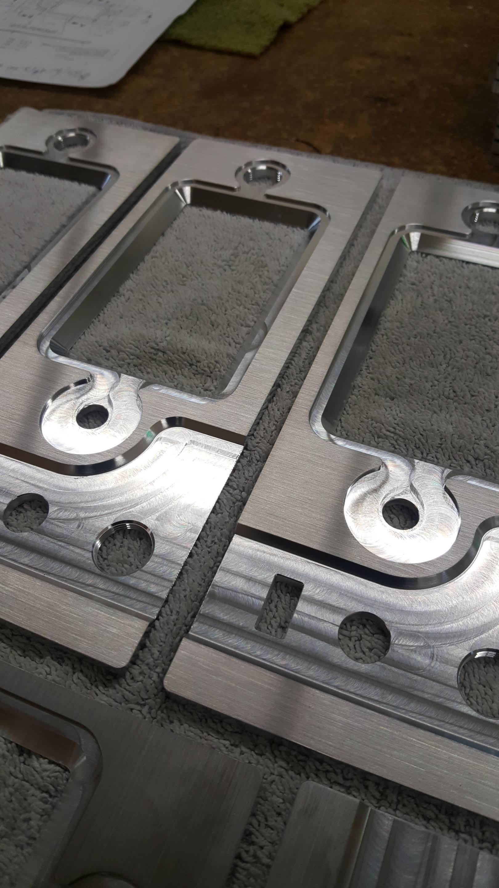 Three pieces of metal are sitting on top of each other on a table.